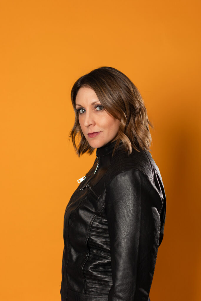 Evoto woman headshot yellow backdrop corporate