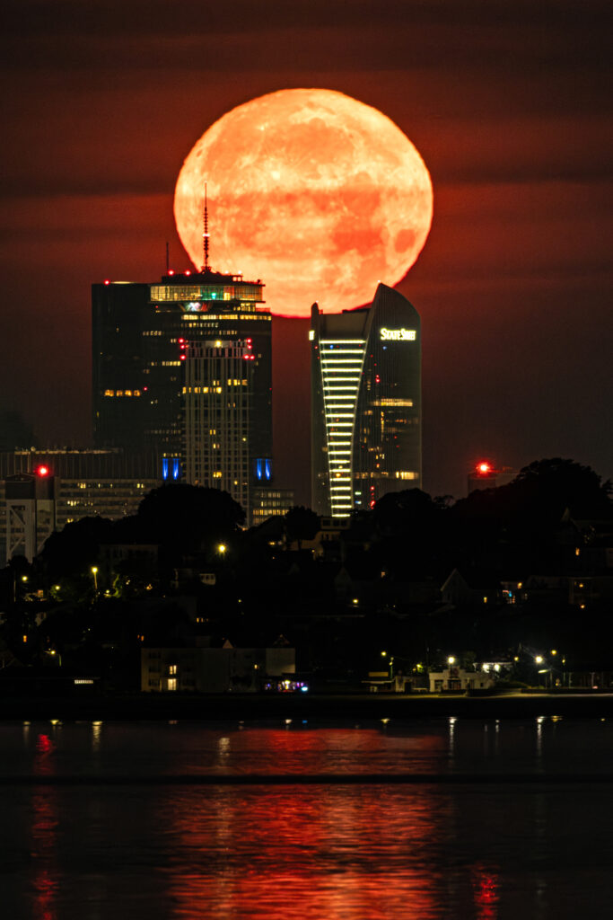 IMGL0456sellIMGL0456 small large full moon setting over boston massachusetts